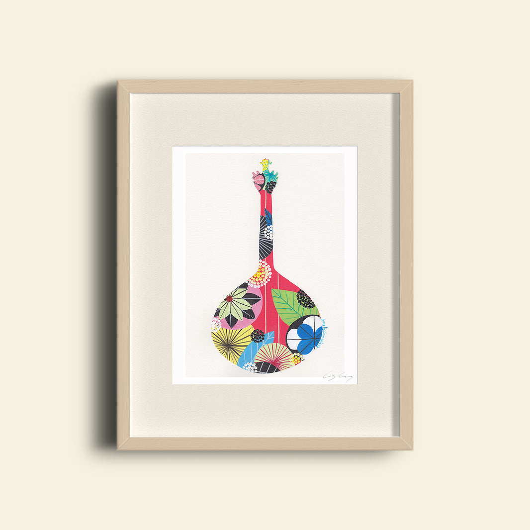 A framed fine art print, by Lis Gonçalves. Open edition, signed by the artist (printed in Hahnemühle matt fibre paper) featuring a colorful Portuguese guitar on a beige wall