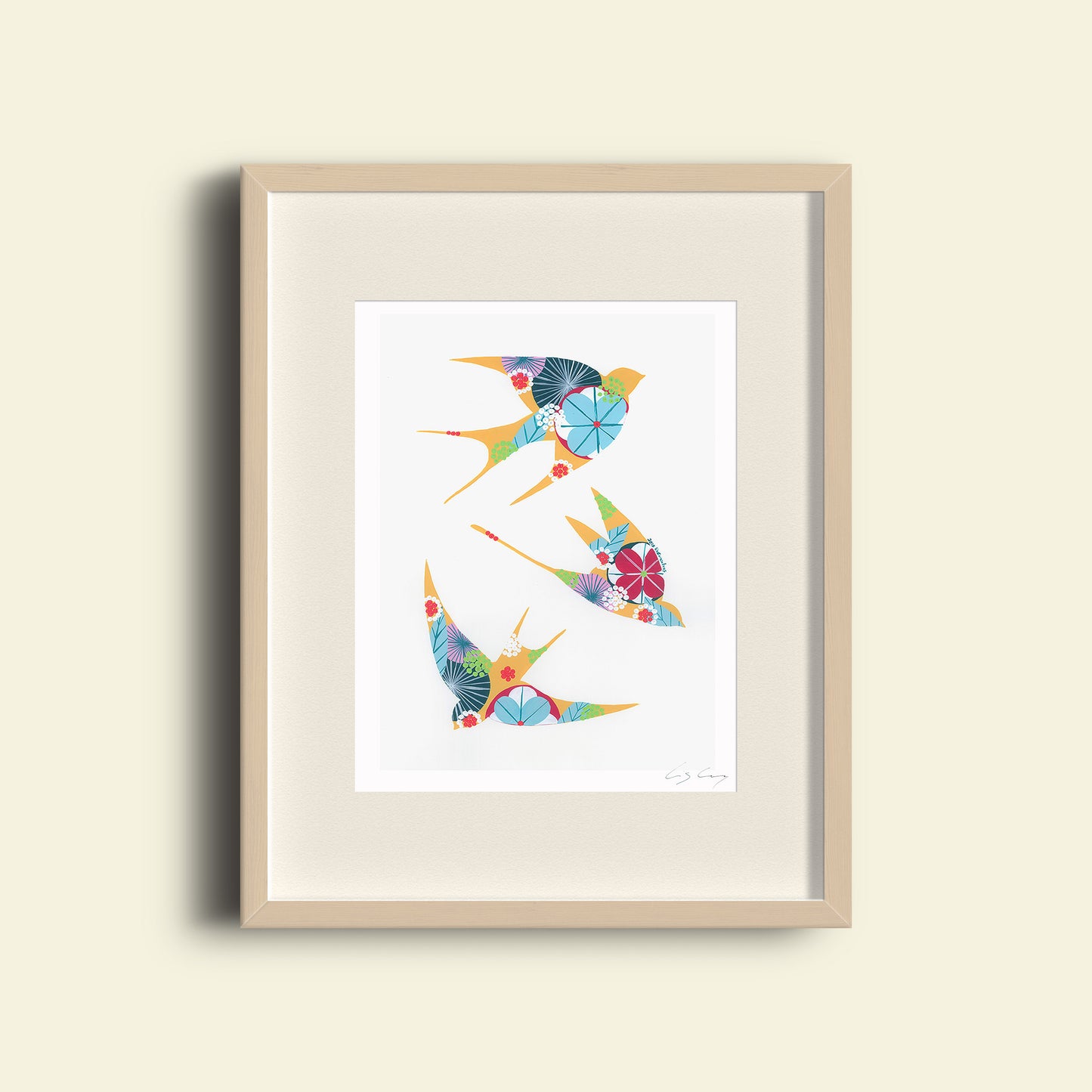 A framed fine art print, by Lis Gonçalves. Open edition, signed by the artist (printed in Hahnemühle matt fibre paper) featuring colorful swallows on a white background