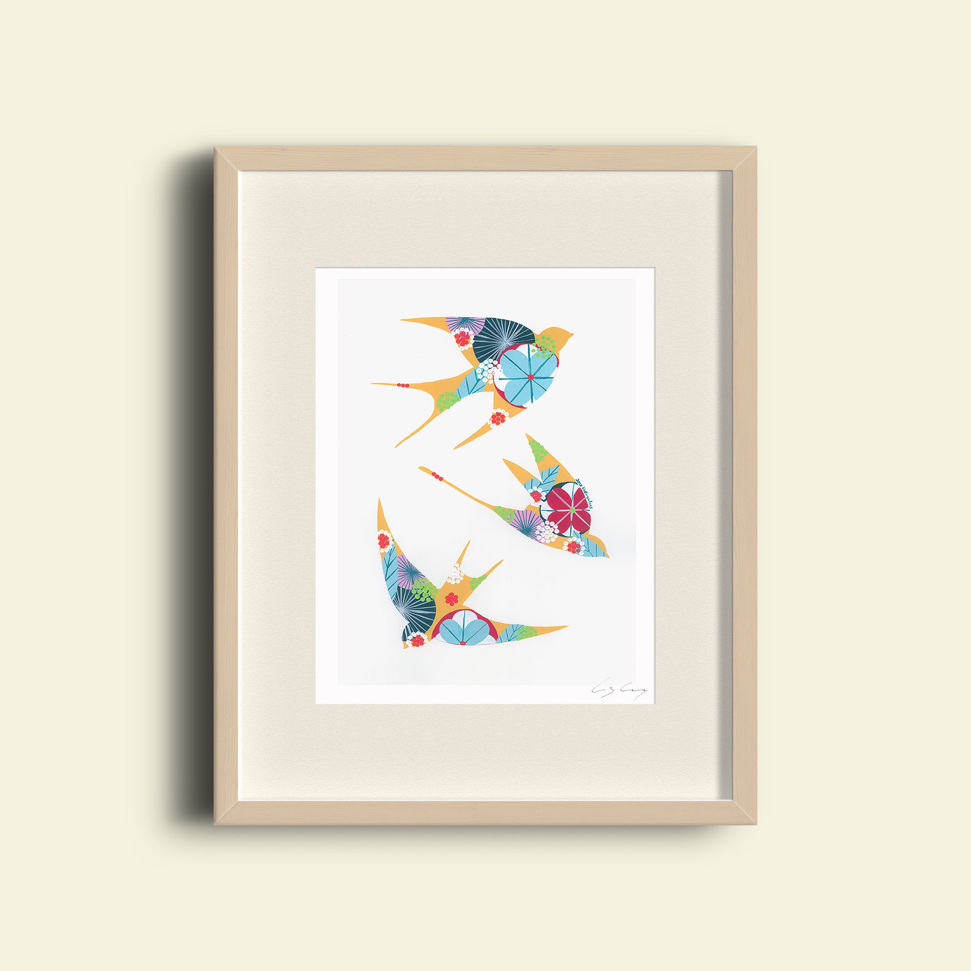 A framed fine art print, by Lis Gonçalves. Open edition, signed by the artist (printed in Hahnemühle matt fibre paper) featuring colorful swallows on a white background