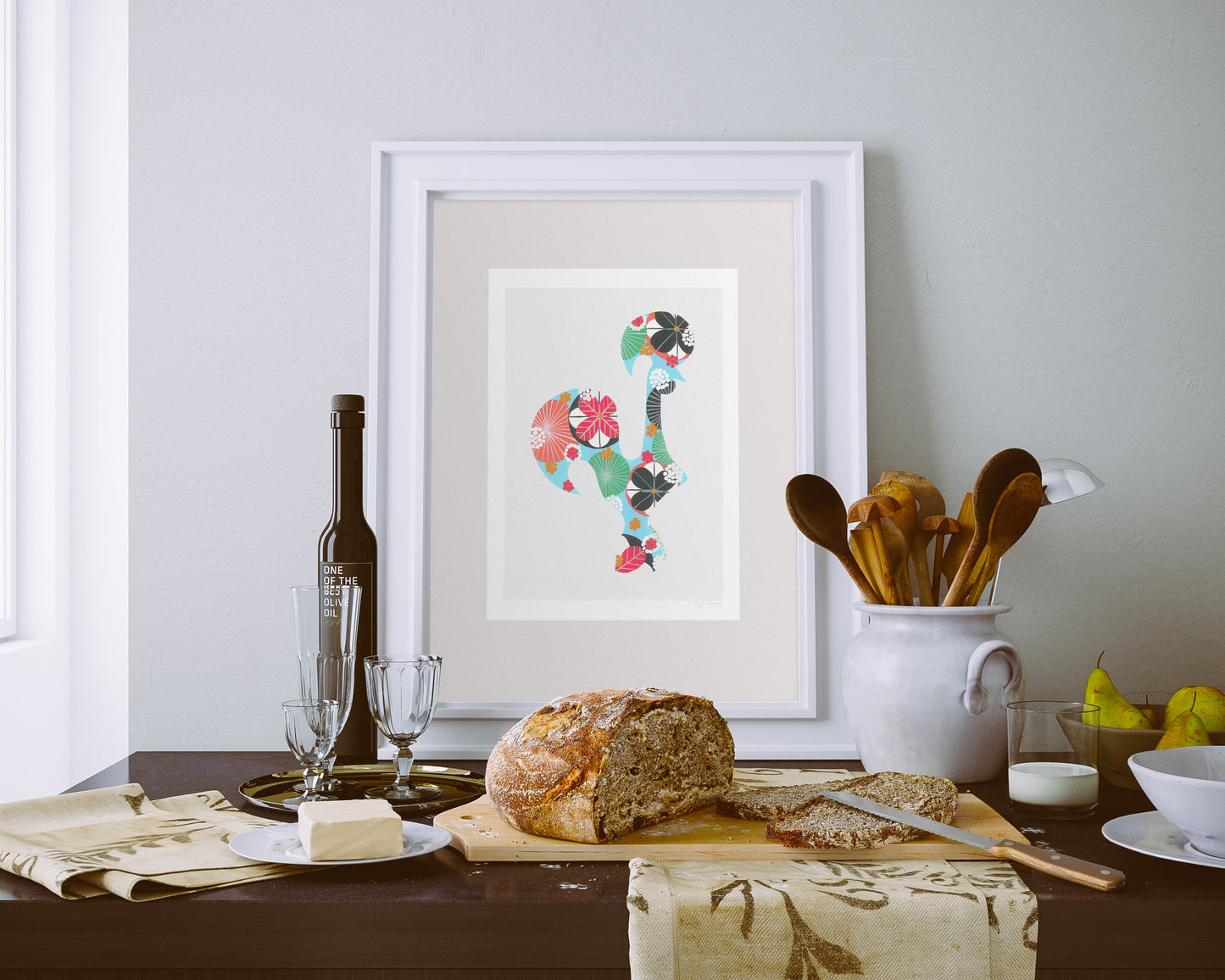 A framed fine art print, by Lis Gonçalves. Open edition, signed by the artist (printed in Hahnemühle matt fibre paper) featuring a colorful Portuguese rooster above a table with bread, wine, and cutlery.
