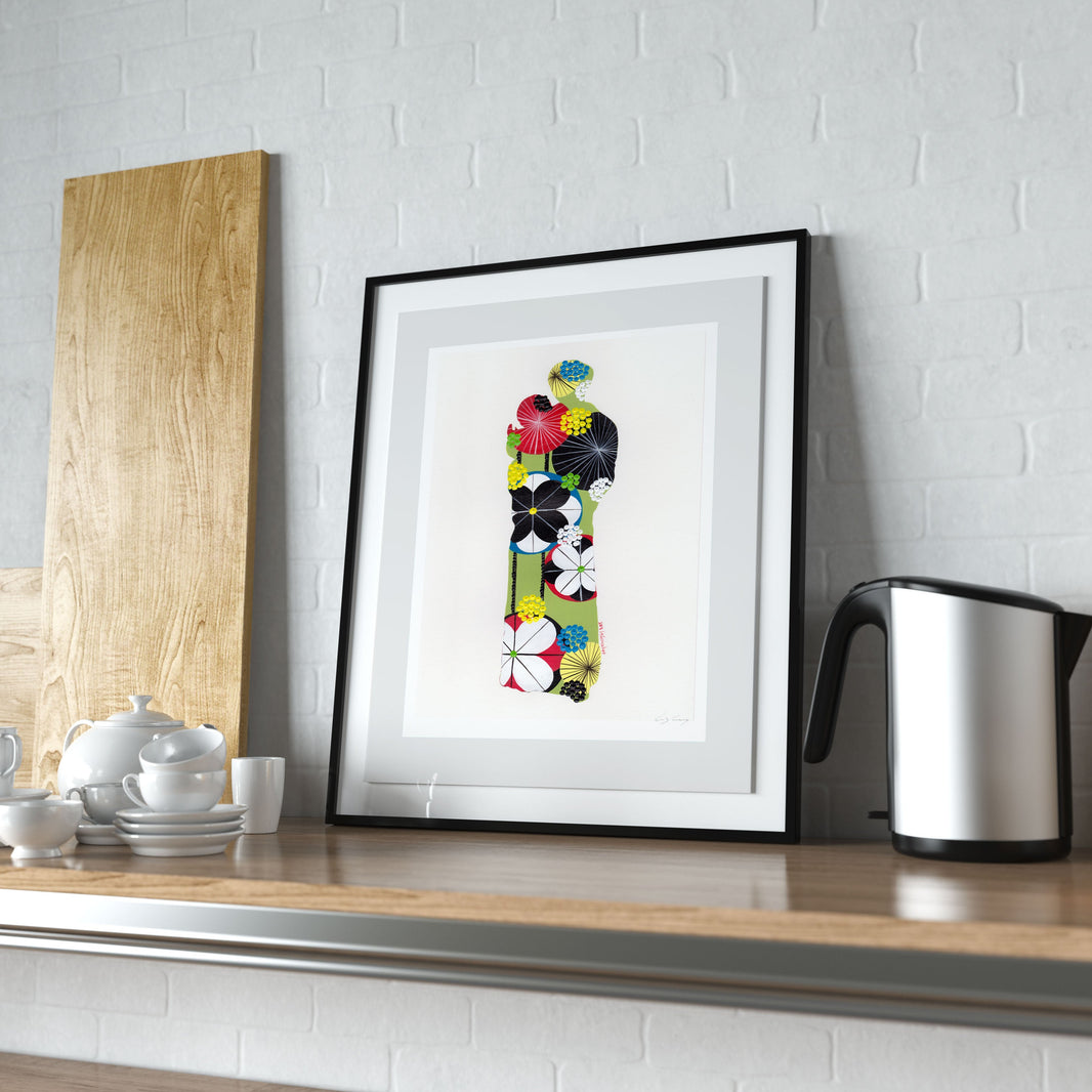 A framed fine art print, by Lis Gonçalves. Open edition, signed by the artist (printed in Hahnemühle matt fibre paper) featuring an image of Saint Anthony on a Kitchen counter with a teapot, and kettle against a white brick wall.