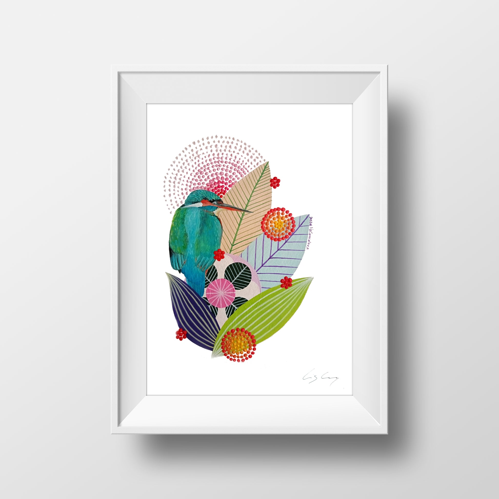 A framed fine art print, by Lis Gonçalves. Open edition, signed by the artist. Printed in Hahnemühle matt fibre paper; featuring a colorful abstract illustration of a green bird, pink flowers, and stylized leaves on a white background, housed in a white frame against a light gray wall.