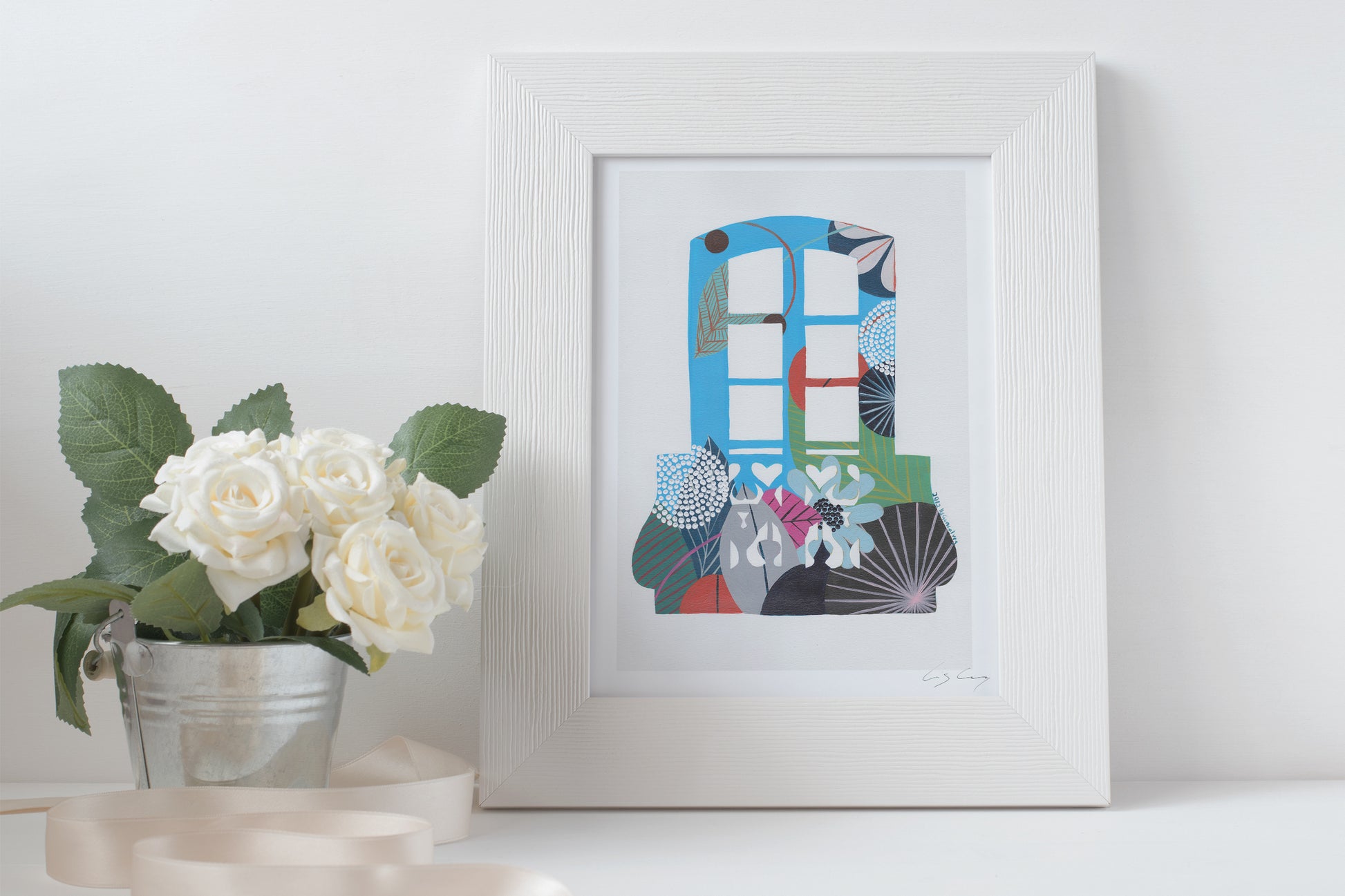 A framed fine art print, by Lis Gonçalves. Open edition, signed by the artist. Printed in Hahnemühle matt fibre paper; featuring an abstract depiction of a Lisbon balcony on a white surface with flowers and candles.