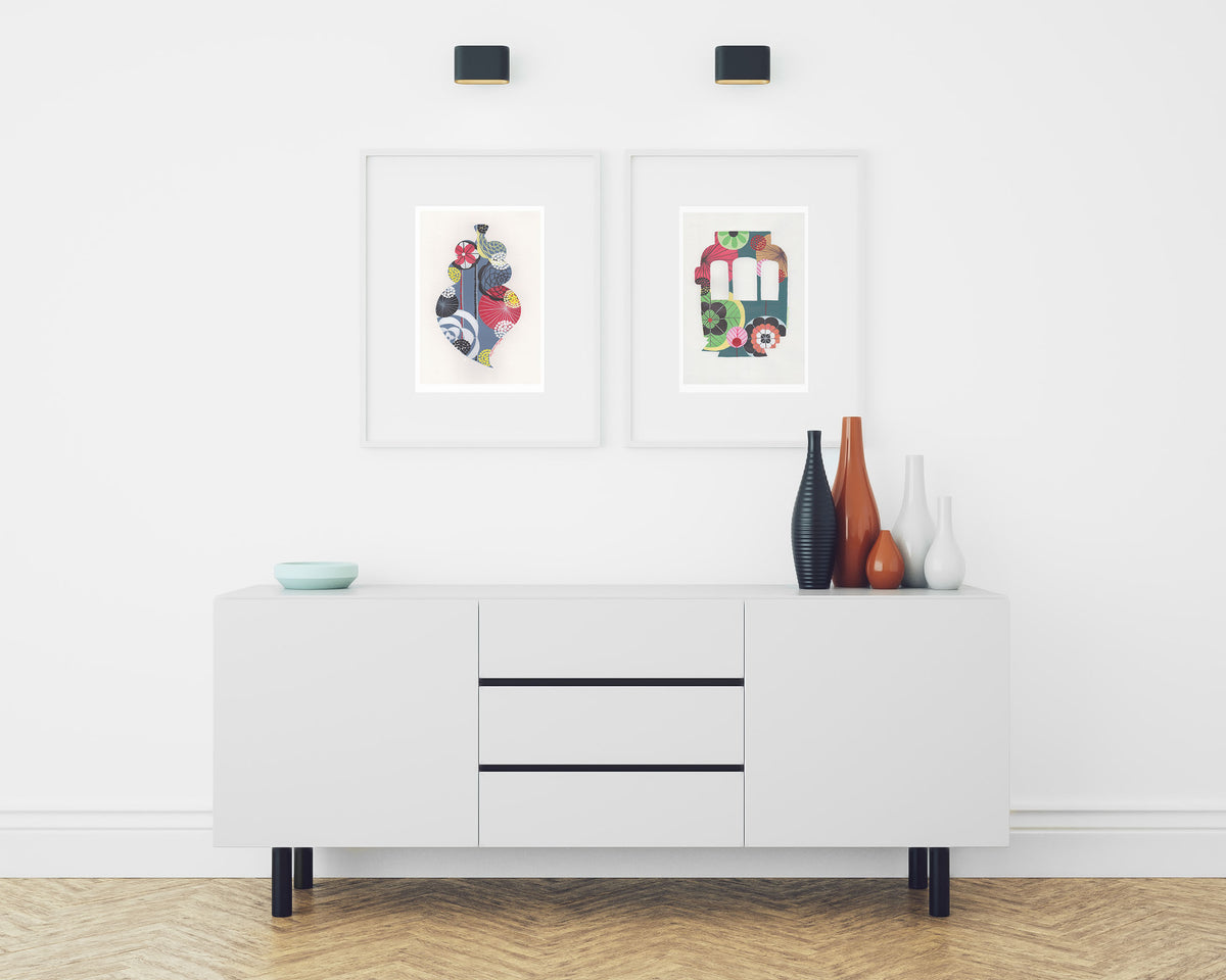 Two framed fine art print, by Lis Gonçalves. Open edition, signed by the artist (printed in Hahnemühle matt fibre paper) featuring a colorful Lisbon tram and a Portuguese heart over a white cabinet with decorative items.