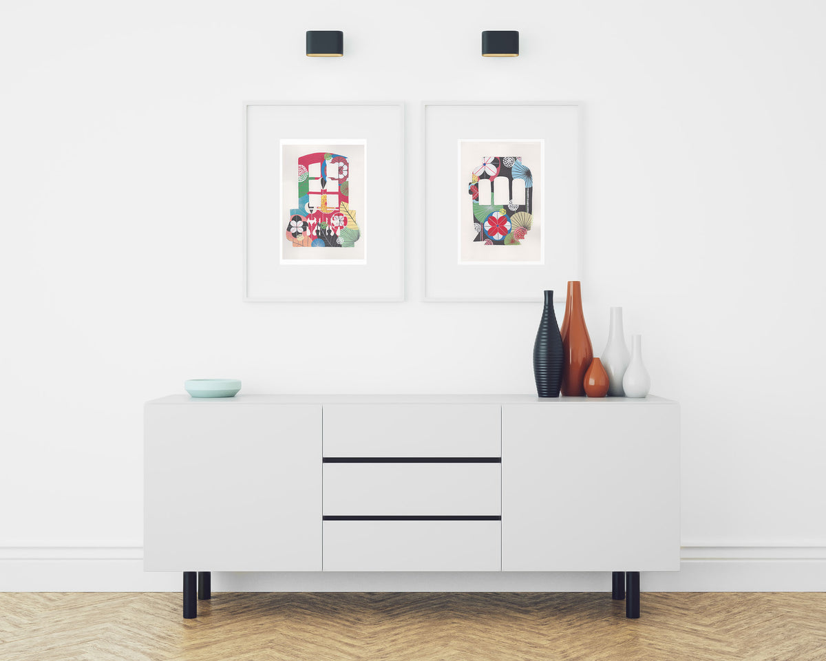 A framed fine art print, by Lis Gonçalves. Open edition, signed by the artist (printed in Hahnemühle matt fibre paper) featuring a colorful Lisbon tram and balcony on a white sideboard with decorative items in a room.