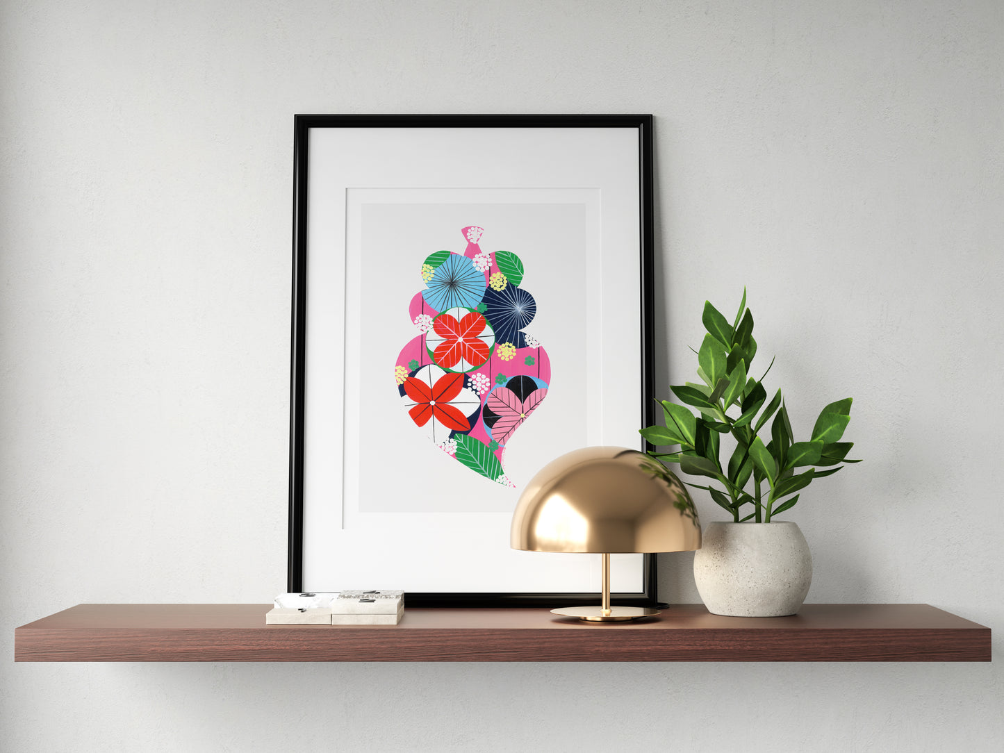 A framed fine art print, by Lis Gonçalves. Open edition, signed by the artist (printed in Hahnemühle matt fibre paper) featuring a colorful Portuguese Viana heart on a wooden shelf with a gold lamp and plant.