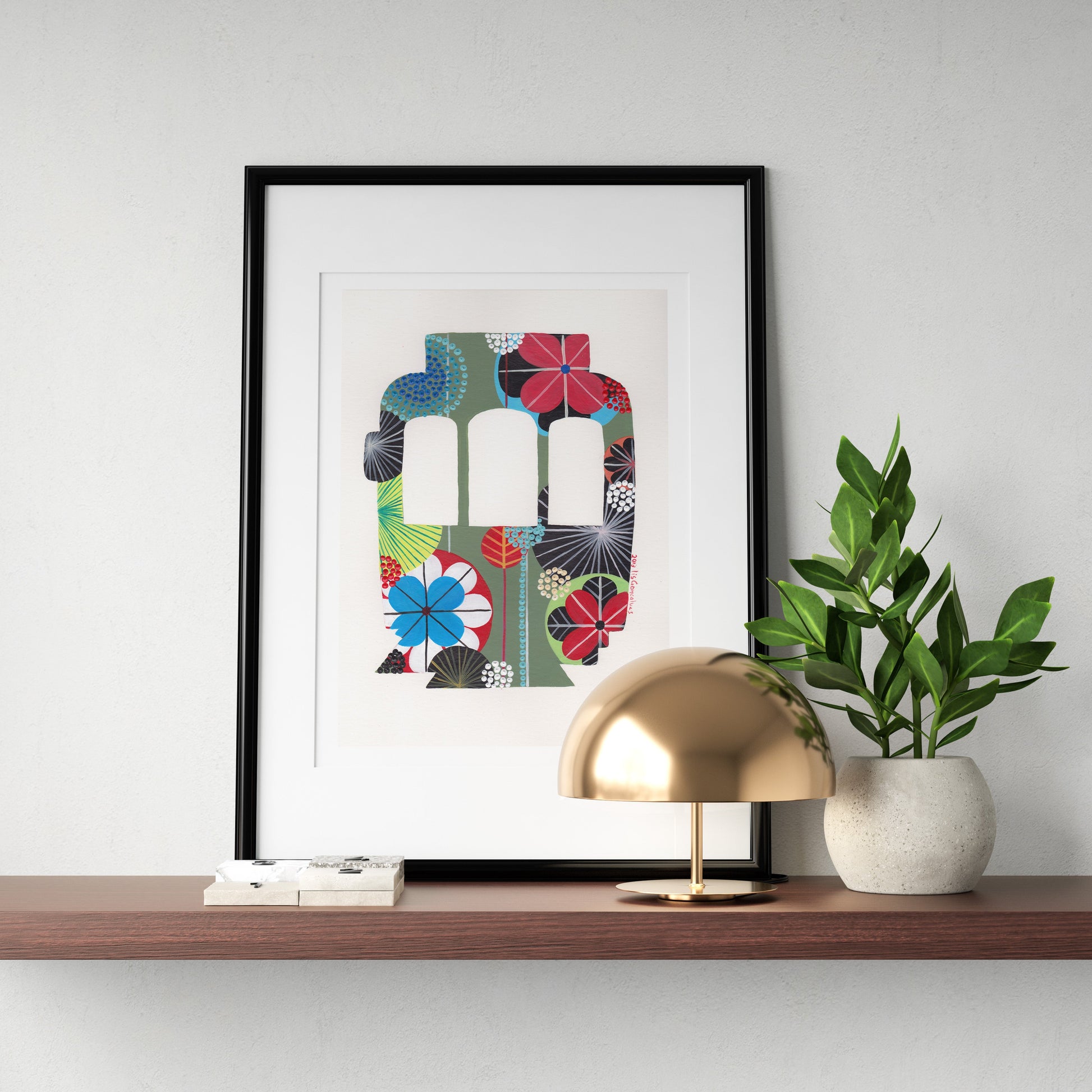 A framed fine art print, by Lis Gonçalves. Open edition, signed by the artist (printed in Hahnemühle matt fibre paper) featuring a colorful Lisbon tram on a wooden shelf with a gold lamp and plant.