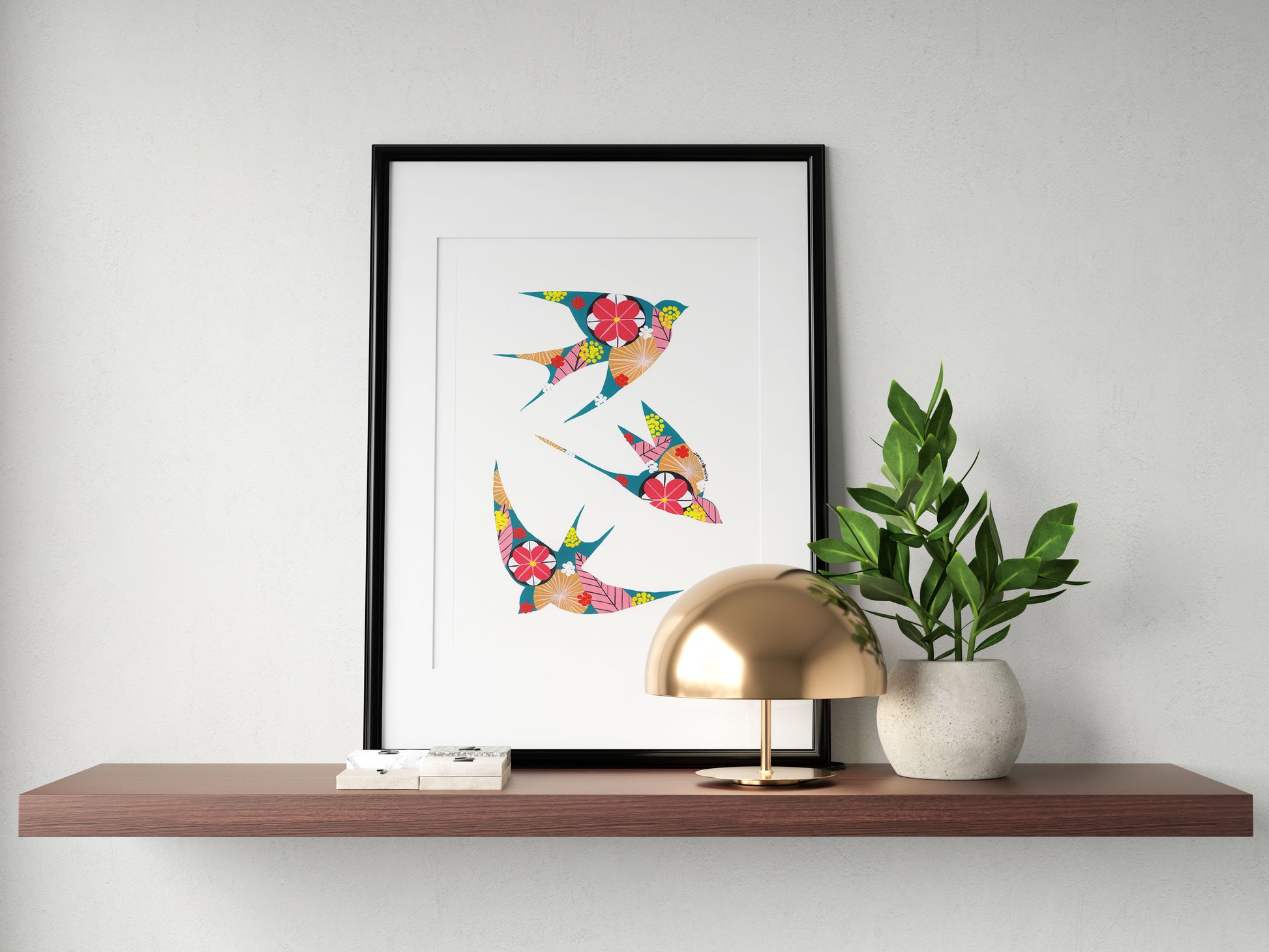 A framed fine art print, by Lis Gonçalves. Open edition, signed by the artist (printed in Hahnemühle matt fibre paper) featuring colorful swallows on a wooden shelf with a lamp and plant.